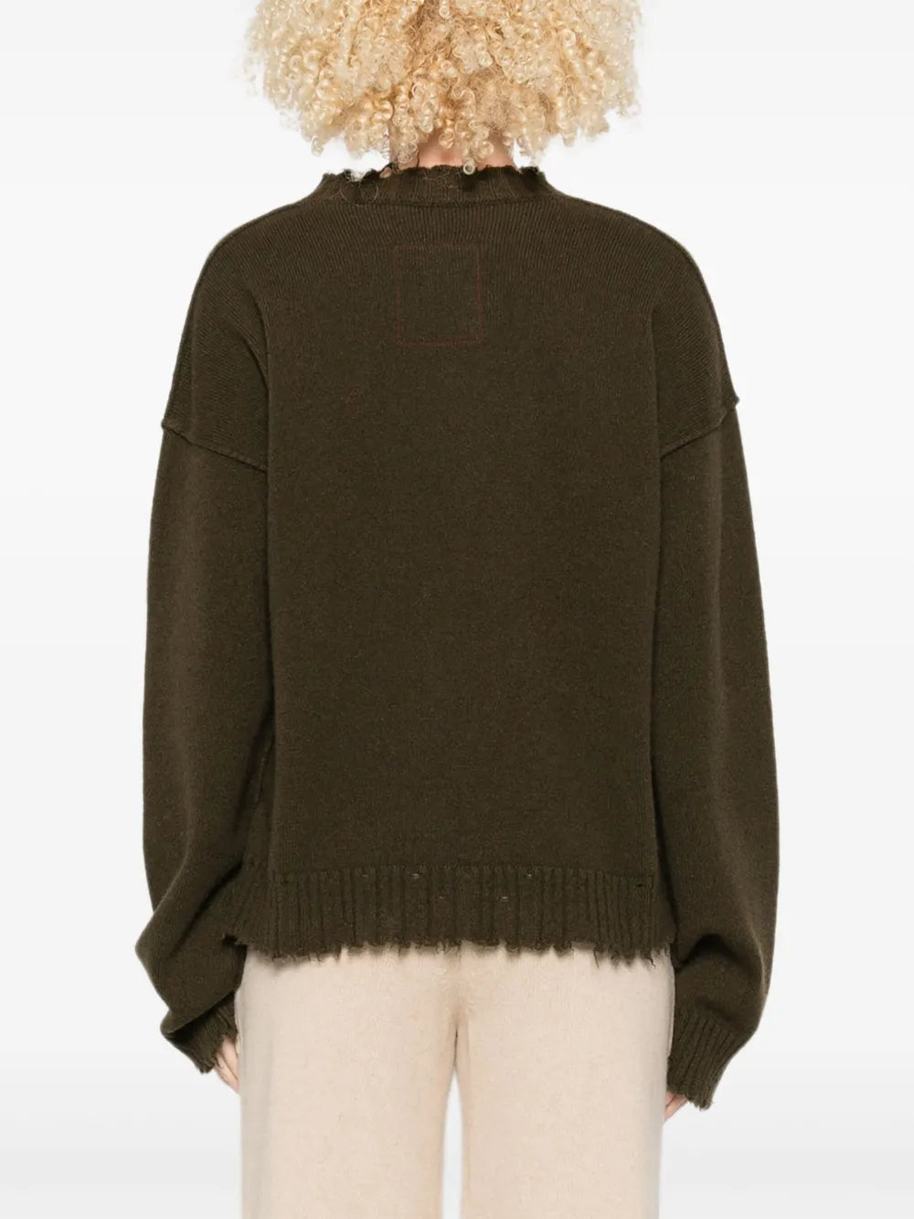 Green top worn by a person, showing the top fit