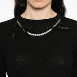 Close up of the black knitwear, showing texture of the merino and silk fabric