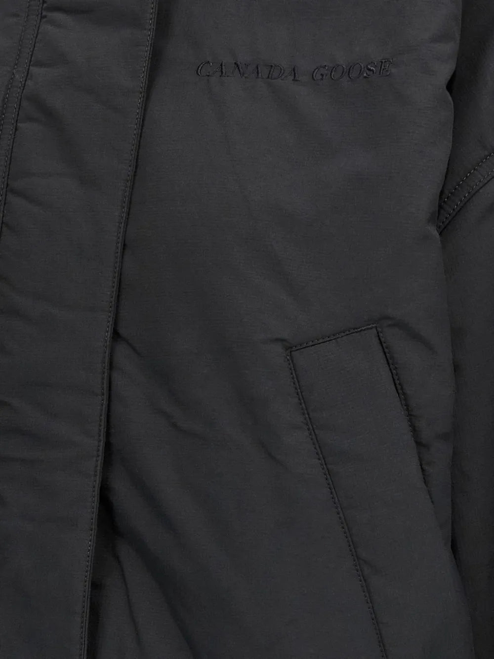 Close up of black jackets, showing texture of the wool and polyester fabric