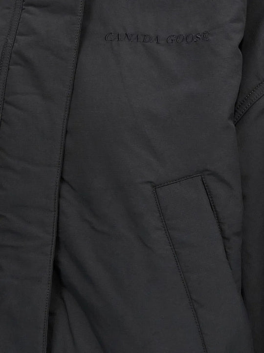 Close up of black jackets, showing texture of the wool and polyester fabric