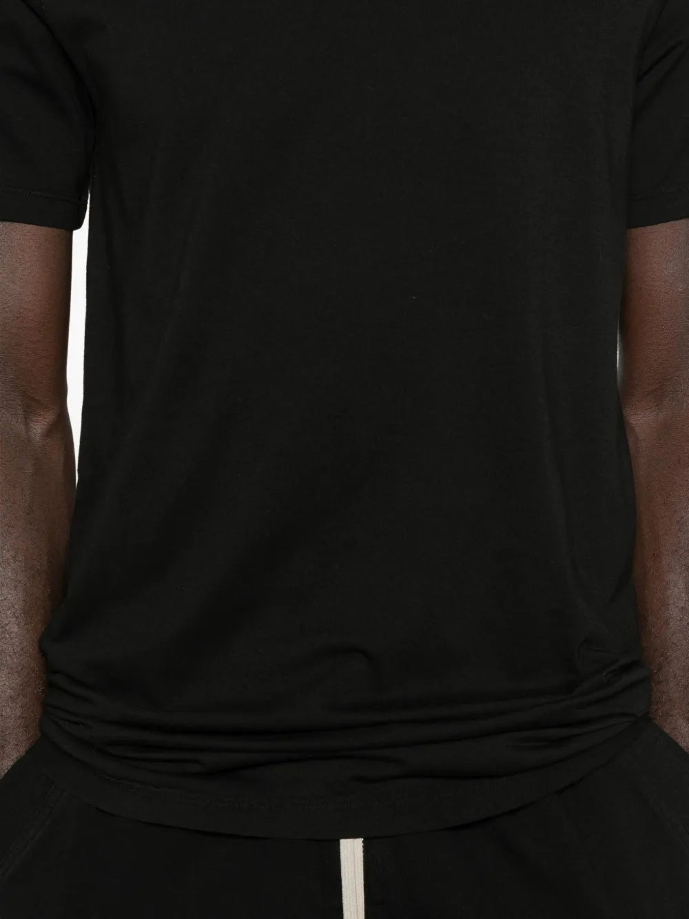 Close up of the black t-shirt, showing texture of the cotton fabric