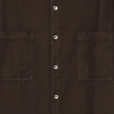 Close up of brown shirts, showing texture of the cotton fabric