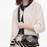 Black bags worn by a person, showing the bags fit