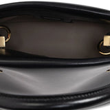 Close up of black bags, showing texture of the calf leather and lamb leather fabric