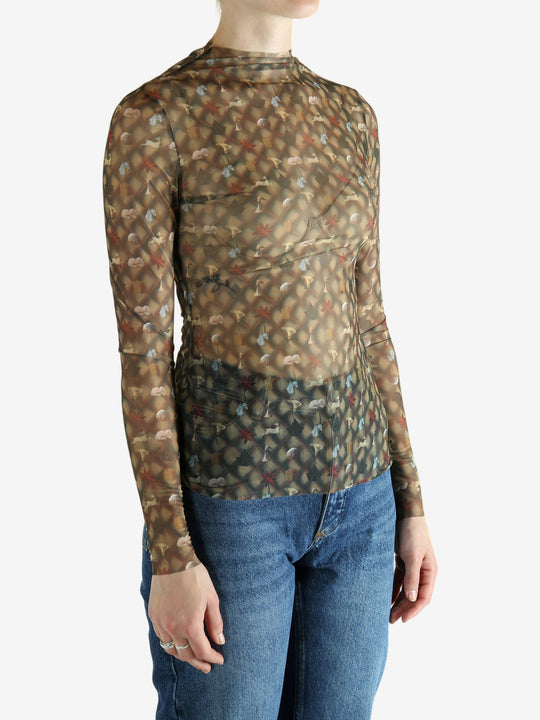 Brown top worn by a person, showing the top's fit