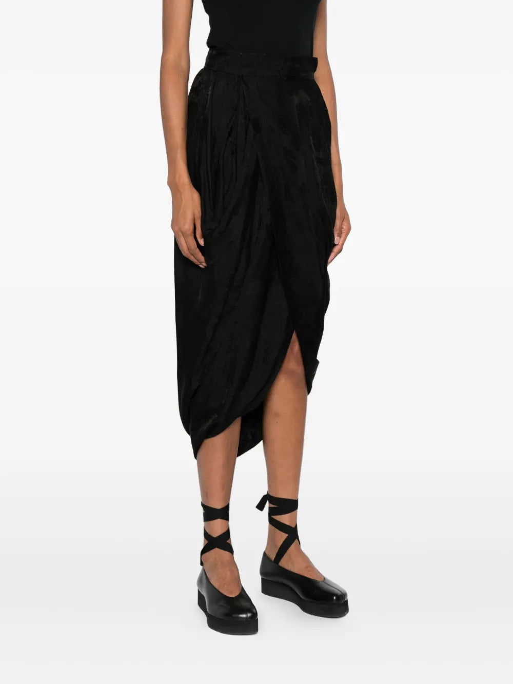 Black skirts worn by a person, showing the skirts fit