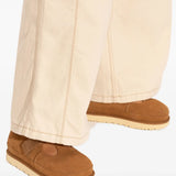 Orange shoes worn by a person, showing the shoes fit