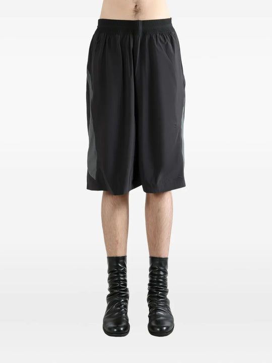 Black shorts worn by a person, showing the shorts's fit