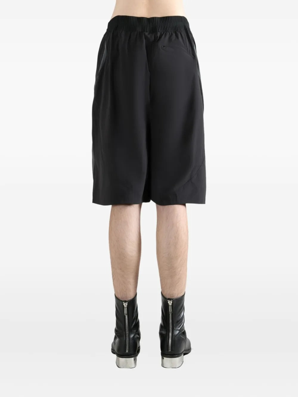 Black shorts worn by a person, showing the shorts's fit