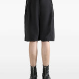 Black shorts worn by a person, showing the shorts's fit