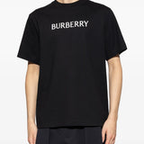 Black t-shirts worn by a person, showing the t-shirts fit