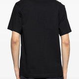 Black t-shirts worn by a person, showing the t-shirts fit