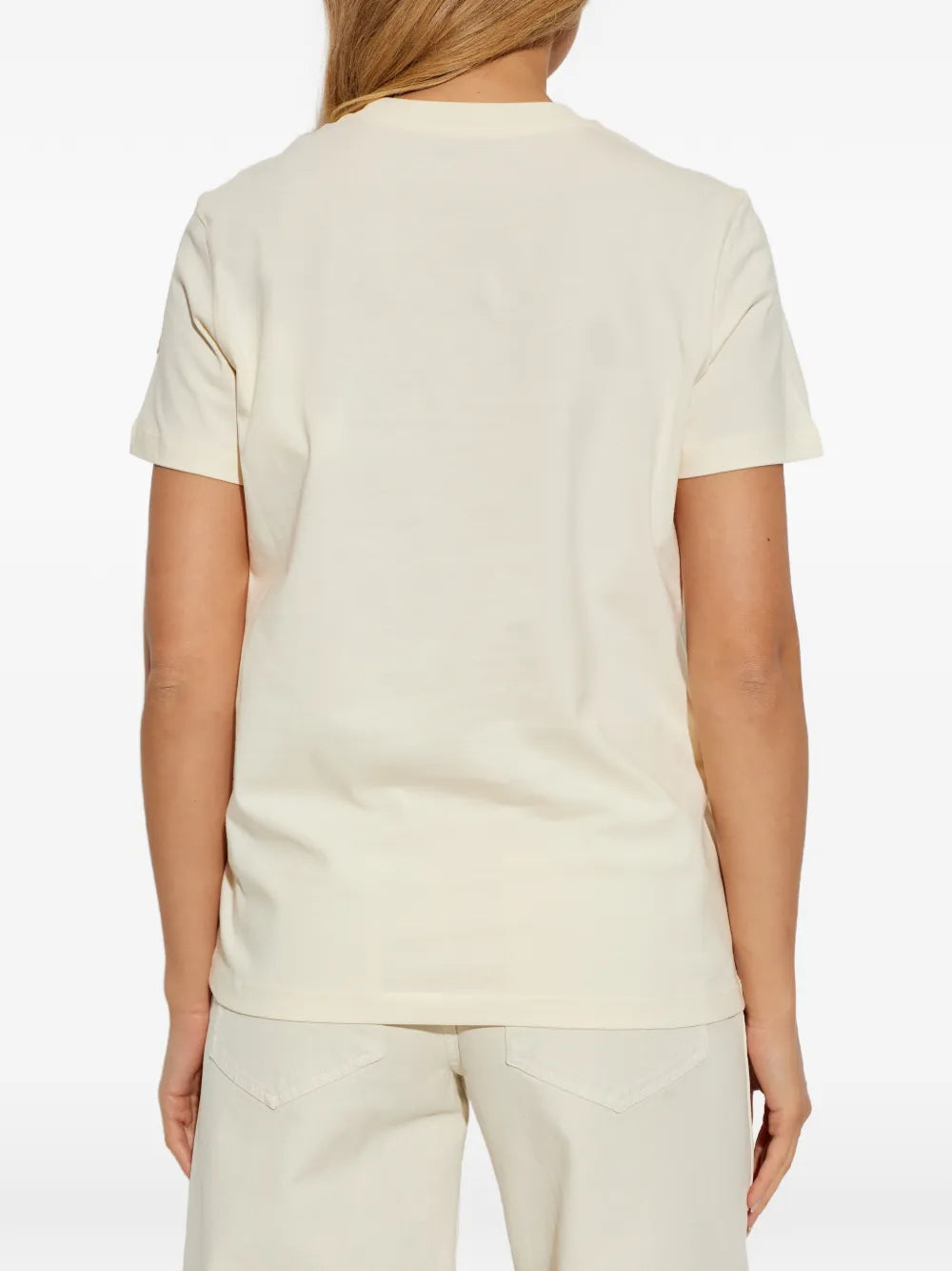 white t-shirt worn by a person, showing the t-shirt fit