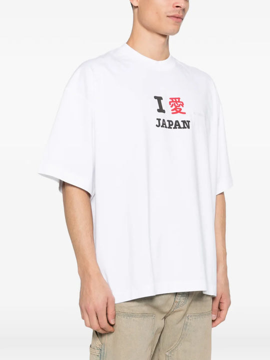 white t-shirt worn by a person, showing the t-shirt fit