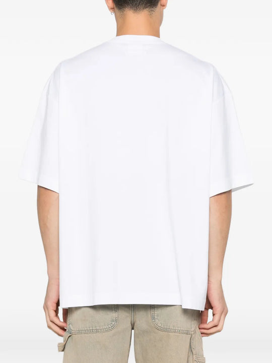 white t-shirt worn by a person, showing the t-shirt fit