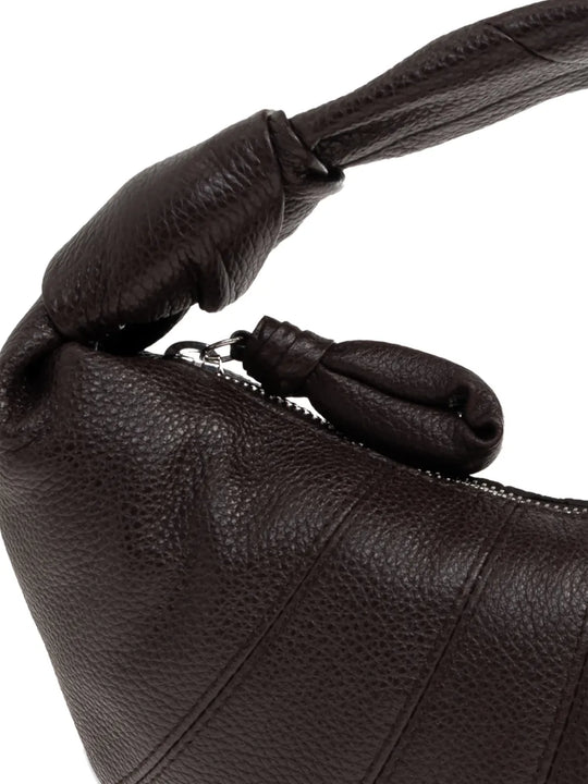 close up of brown bags, showing texture of the cow leather fabric