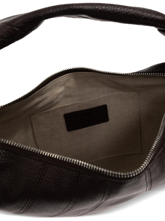 close up of brown bags, showing texture of the cow leather fabric