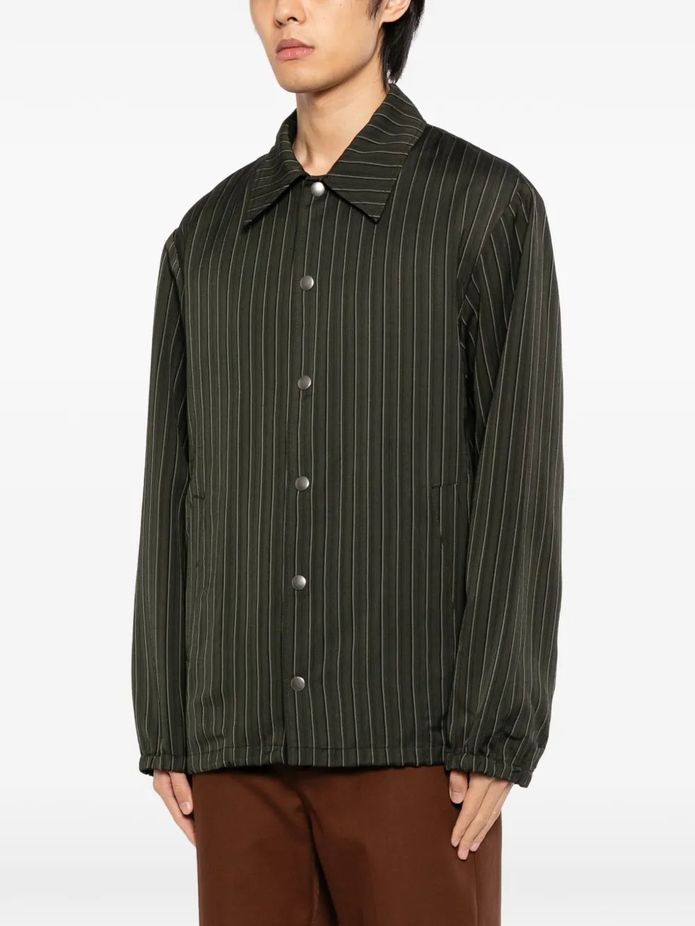 Green jackets-coats worn by a person, showing the jackets-coats'fit