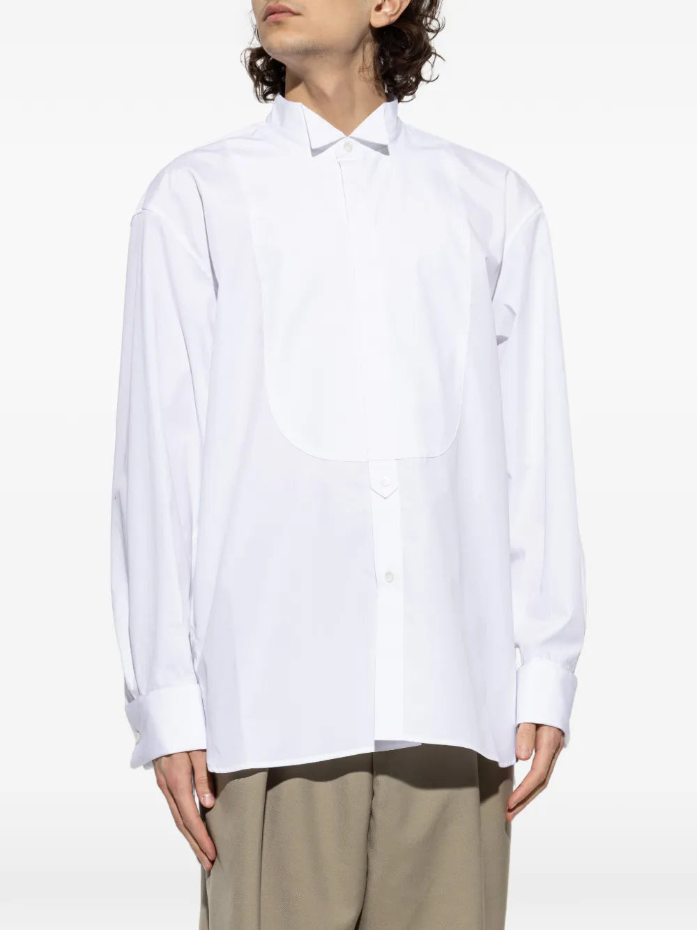 White shirt worn by a person, showing the shirt'fit