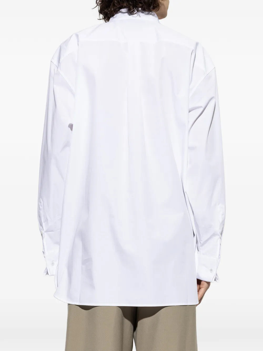 White shirt worn by a person, showing the shirt'fit