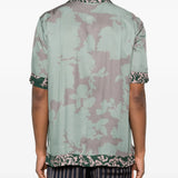 Green shirt worn by a person, showing the shirt'fit