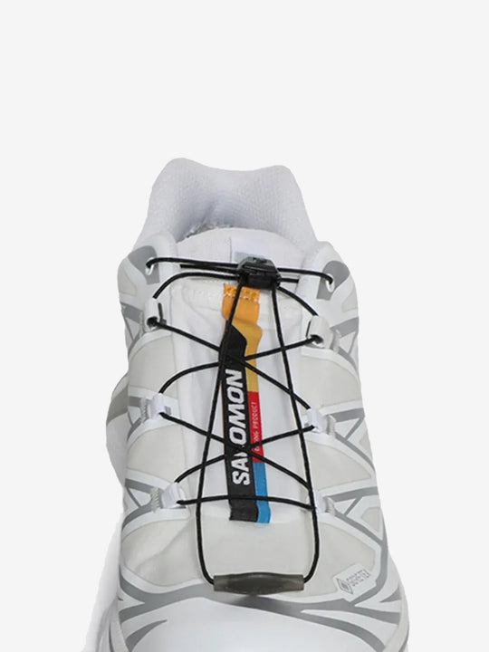 Close up of the white sneakers, showing texture of the fibres fabric