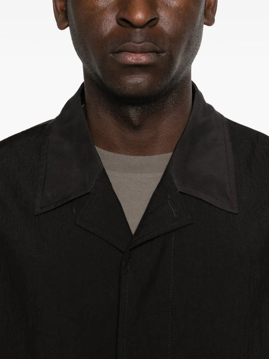 Close up of black jacket, showing texture of the linen fabric