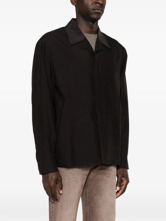 Black jacket worn by a person, showing the jacket's fit