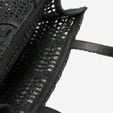 Close up of the black bag, showing texture of the straw fabric