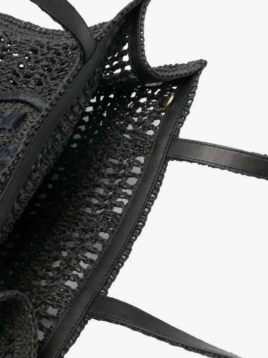 Close up of the black bag, showing texture of the straw fabric