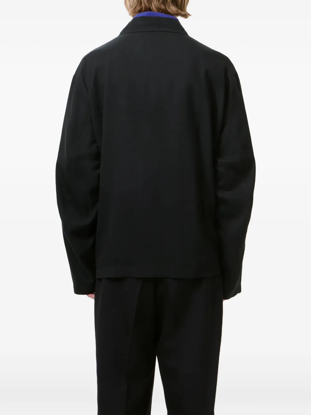 Black jackets worn by a person, showing the jackets fit