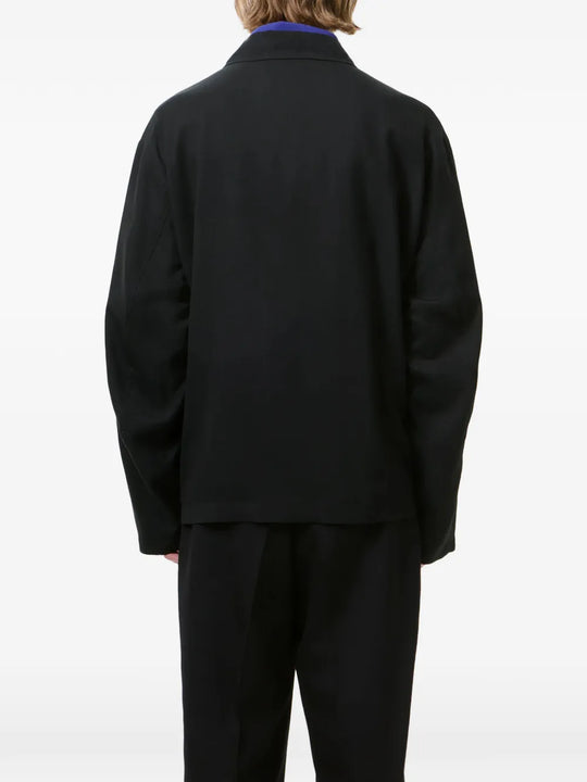 Black jackets worn by a person, showing the jackets fit