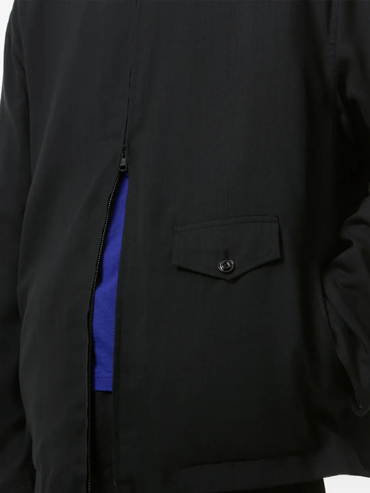 Close up of Black jacket, showing texture of the super merino wool fabric