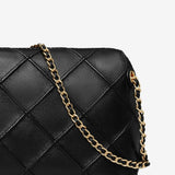 Close up of black bag, showing texture of the leather fabric