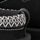 Close-up of a black boot,showing texture of the suede fabric.