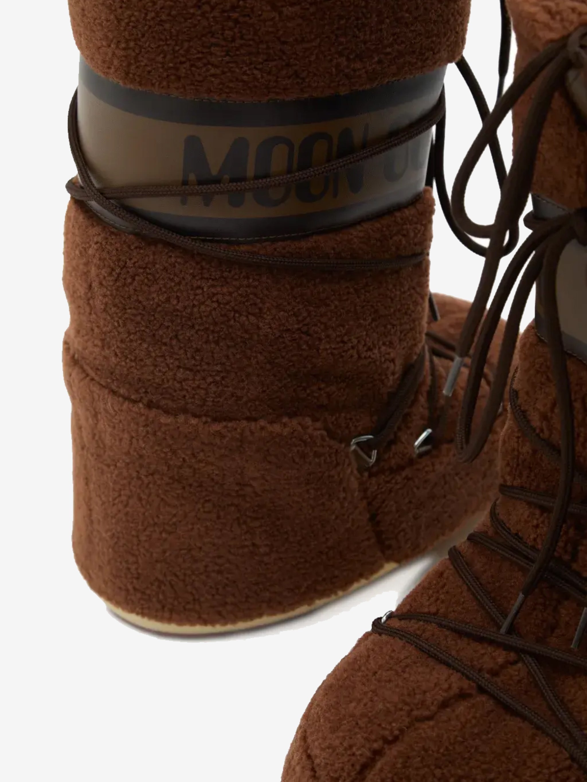 Close up of the brown boot, showing texture of the acrylic/  polyester/ polyvinyl chloride fabric