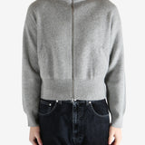 gray zip-up sweater worn by a person, showing the sweater fit