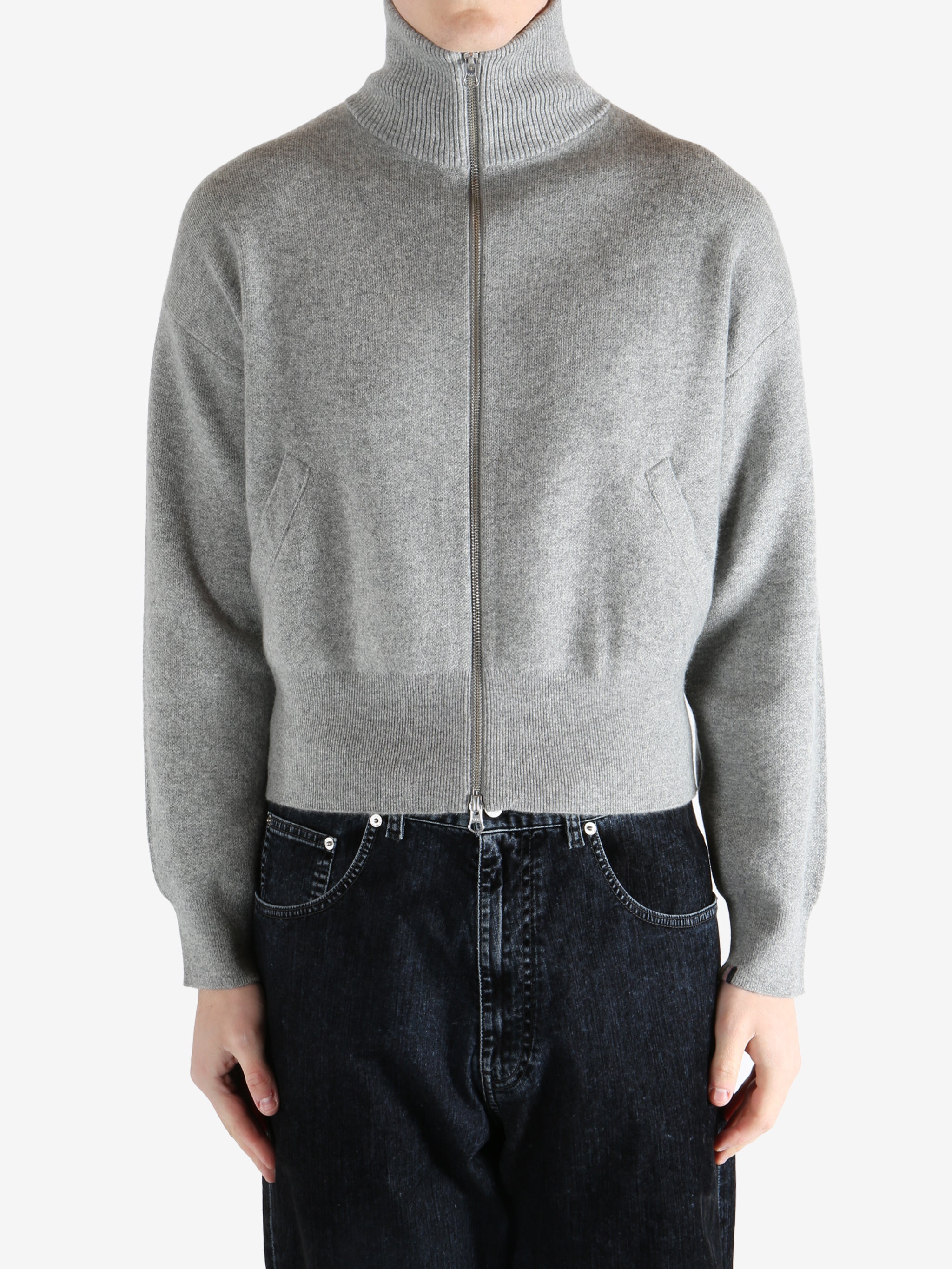gray zip-up sweater worn by a person, showing the sweater fit