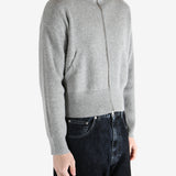 gray zip-up sweater worn by a person, showing the sweater fit