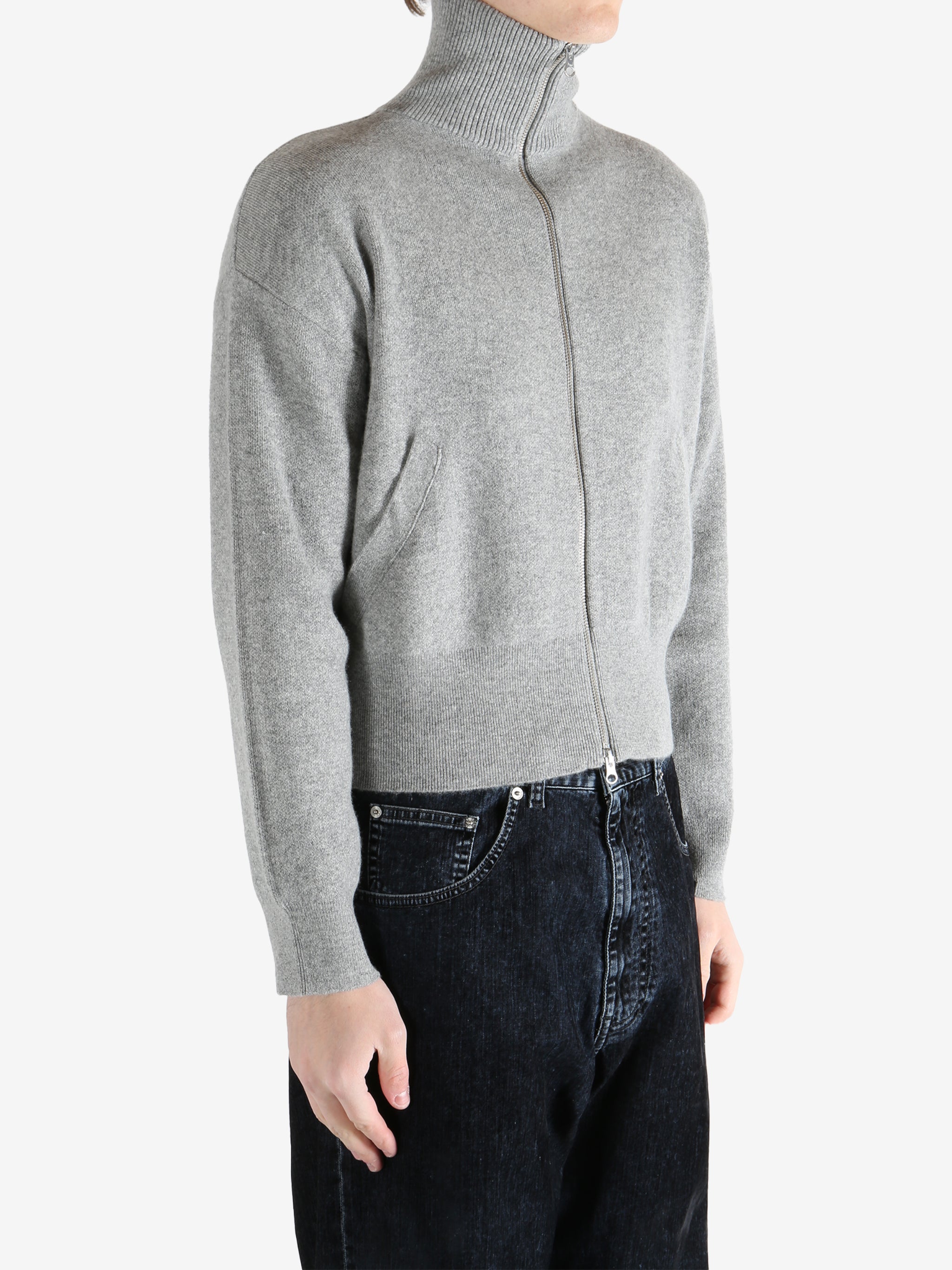 gray zip-up sweater worn by a person, showing the sweater fit