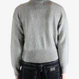 gray zip-up sweater worn by a person, showing the sweater fit