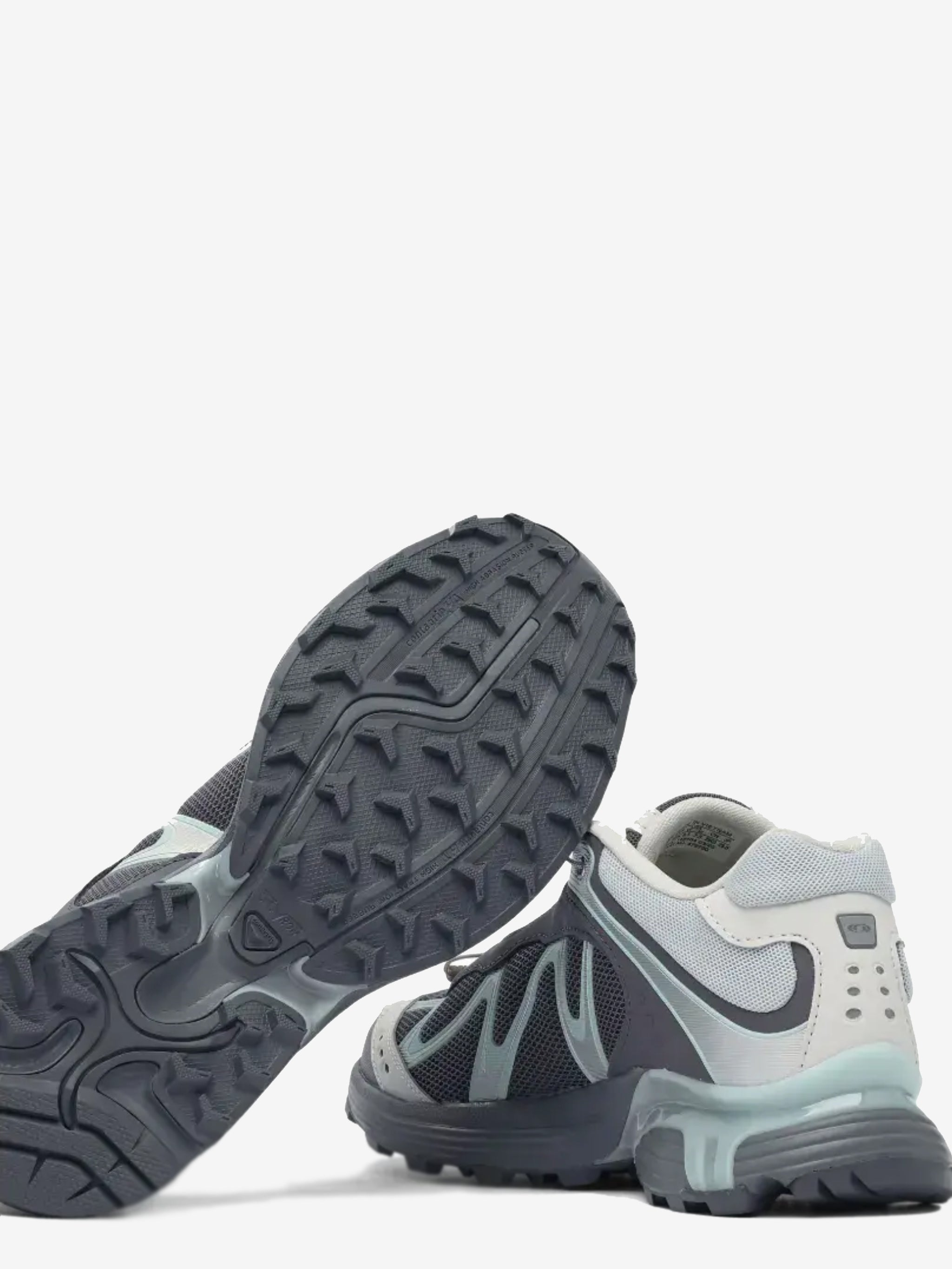 Close up of the grey sneakers, showing texture of the rubber fabric