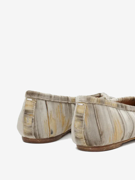 Close up of the tan shoes, showing texture of the viscose fabric