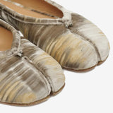 Close up of the tan shoes, showing texture of the viscose fabric
