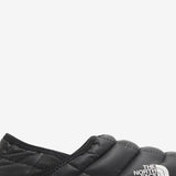 Close up of the black sneakers, showing texture of the polyester fabric