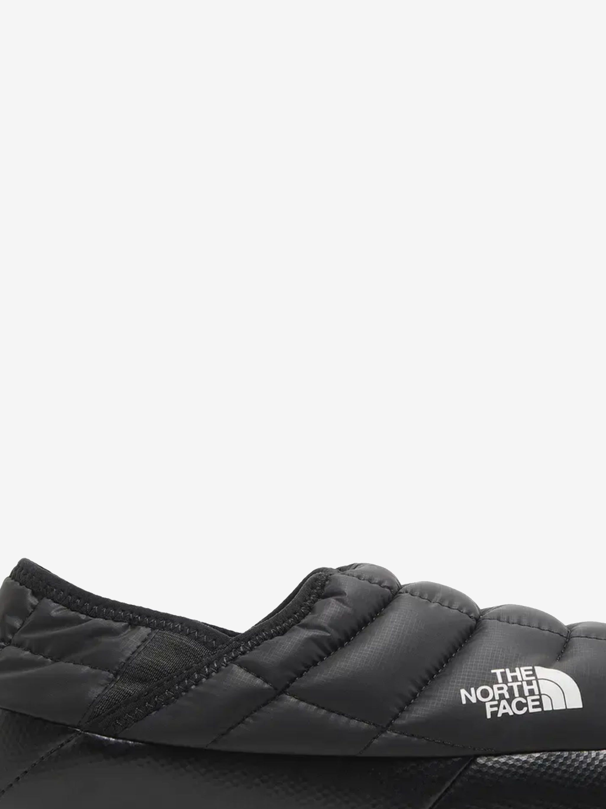 Close up of the black sneakers, showing texture of the polyester fabric