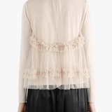 tan shirt worn by a person, showing the shirt fit
