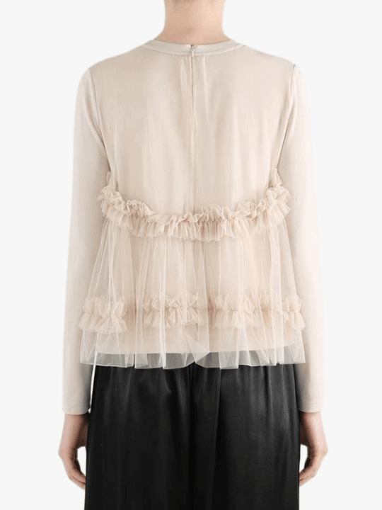 tan shirt worn by a person, showing the shirt fit
