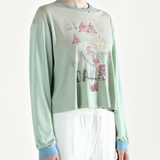 Blue t-shirt worn by a person, side view