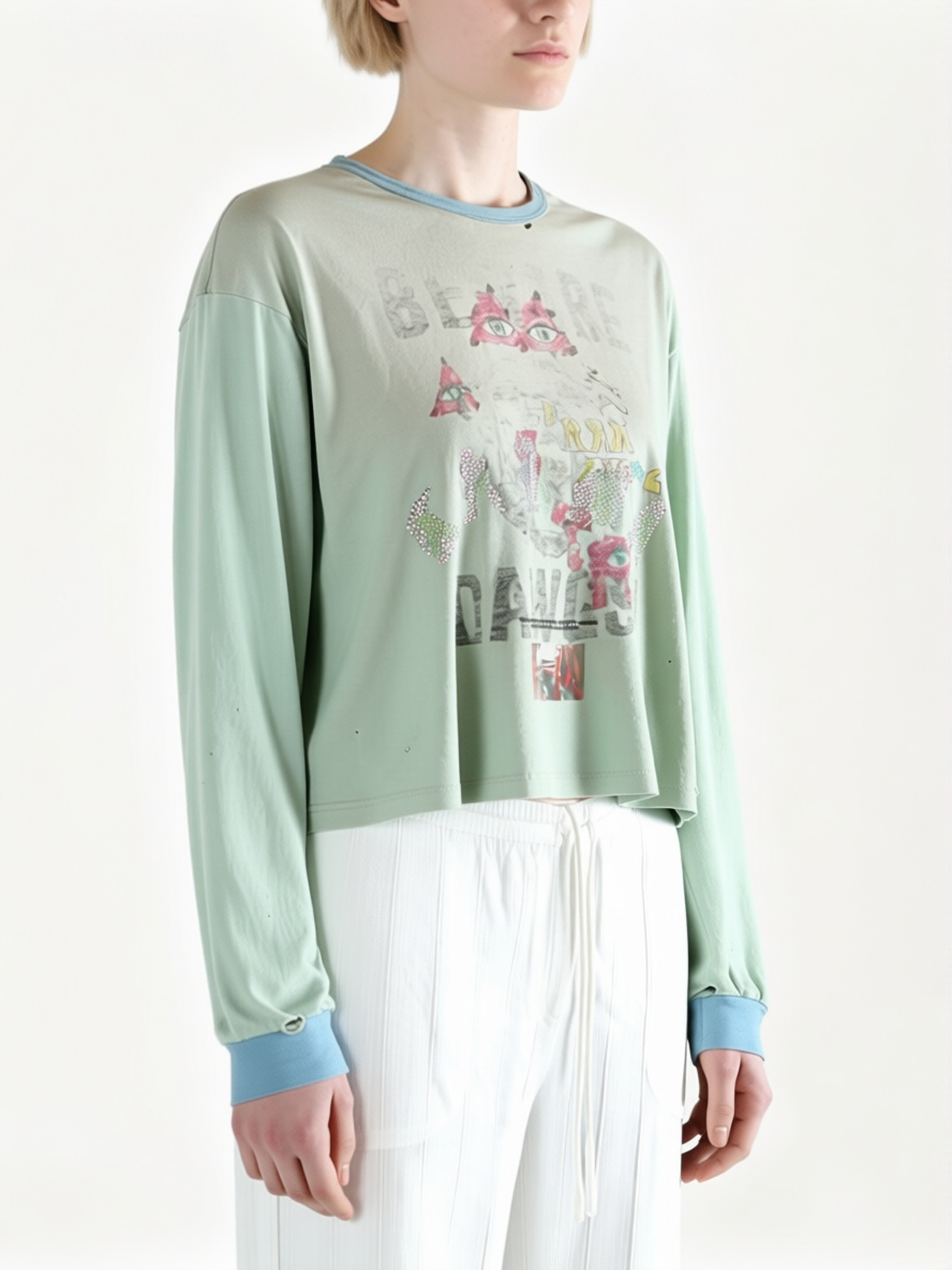 Blue t-shirt worn by a person, side view